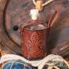 Big glass bottle with a Fleur-de-lys carved leather belt holder